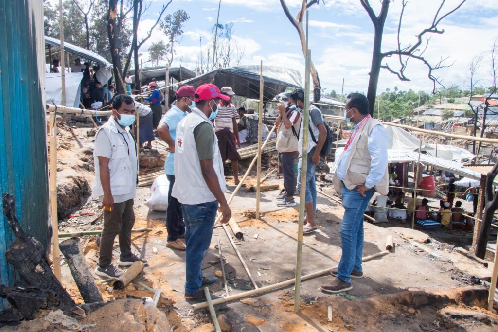 Caritas Bangladesh personnel surveying fire damage