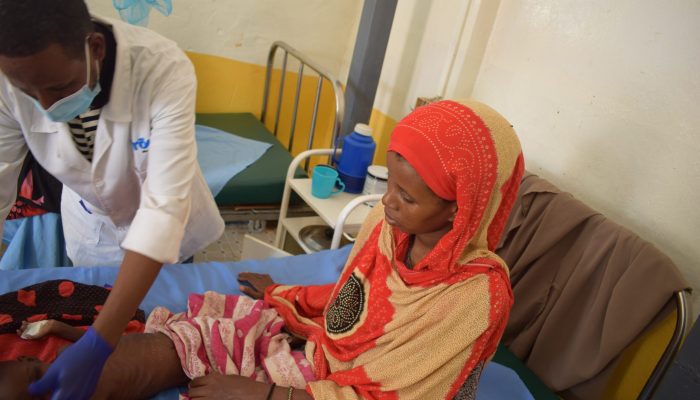 AbdiKarin Nutrition nurse performing physical examination on baby Hodhan Ali Abshir admitted at Dollow Referral Health Centre.